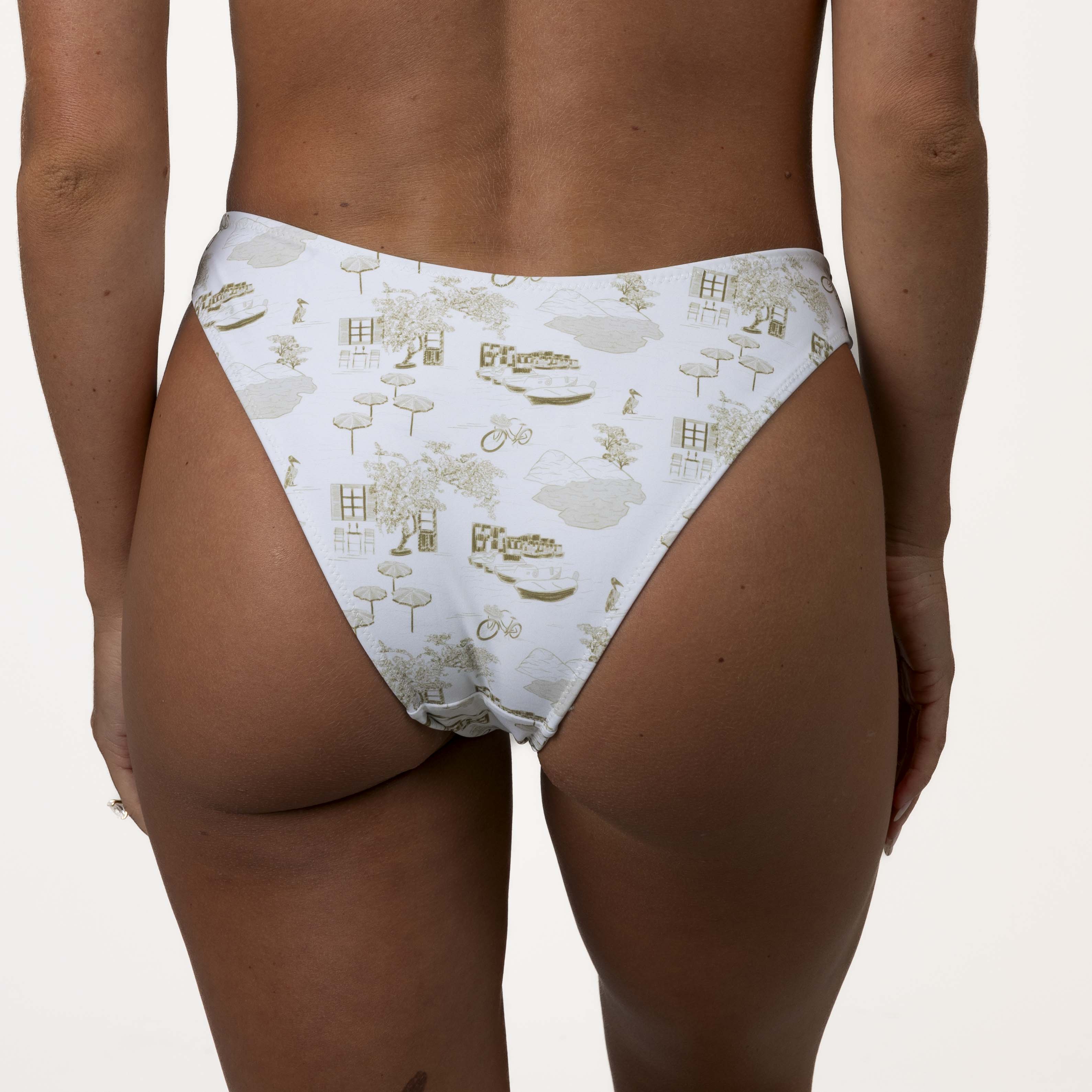 Person wearing Honey Swims Serenity Underwire Set high-waisted white bikini bottoms with a beige house, bicycle, and tree pattern. These European-style bottoms offer enhanced support.