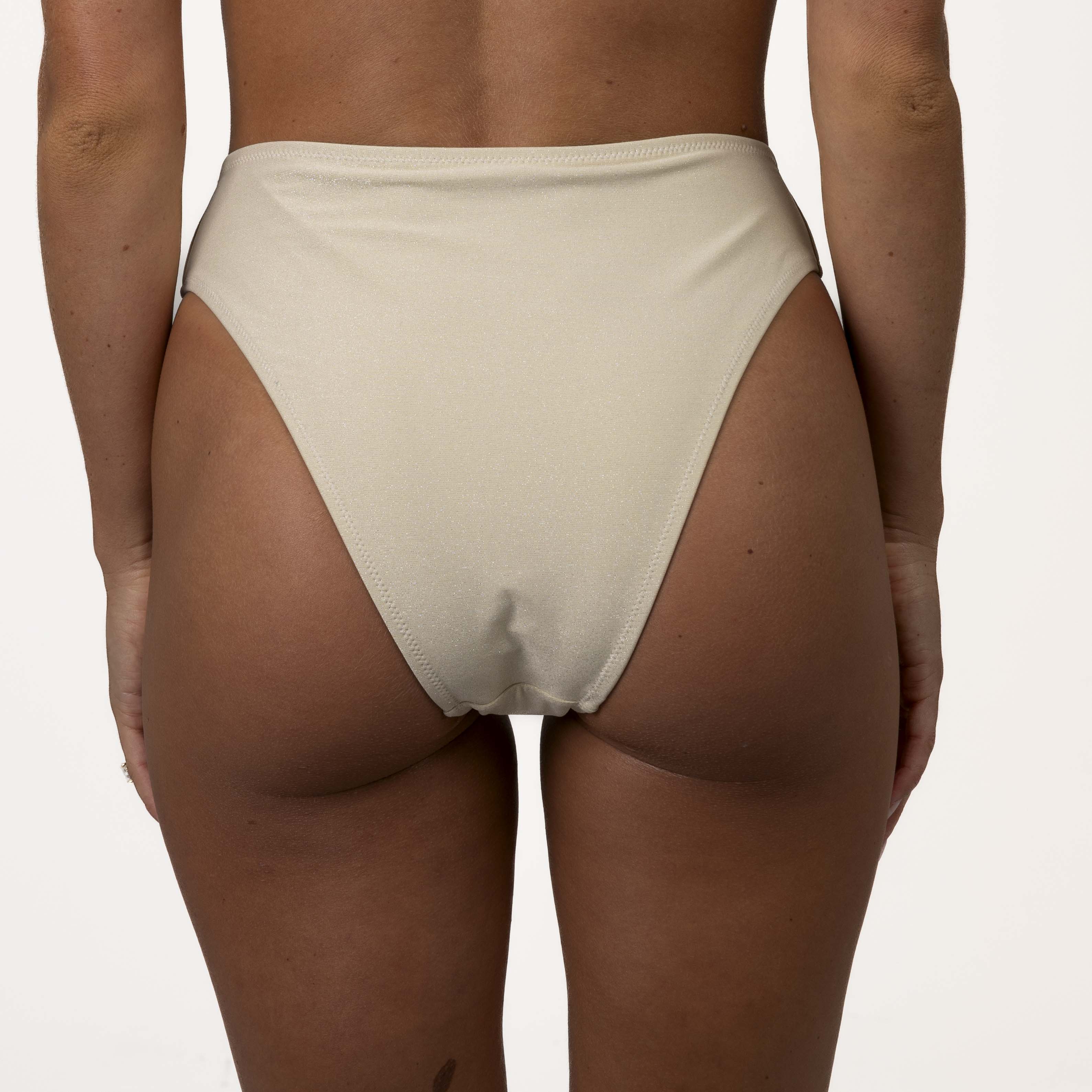 Rear view of a person wearing the Honey Swim Champagne Shimmer Bandeau Set, showcasing high-waisted, light-colored bikini bottoms with a strapless tie-back design against a plain background.