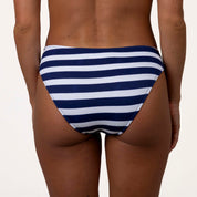 A person models Honey Swims Athens Ribbed Full Coverage Bottoms, showcasing the blue and white horizontal stripes and comfortable stretchy fabric against a plain background, focusing on the lower back and hips.