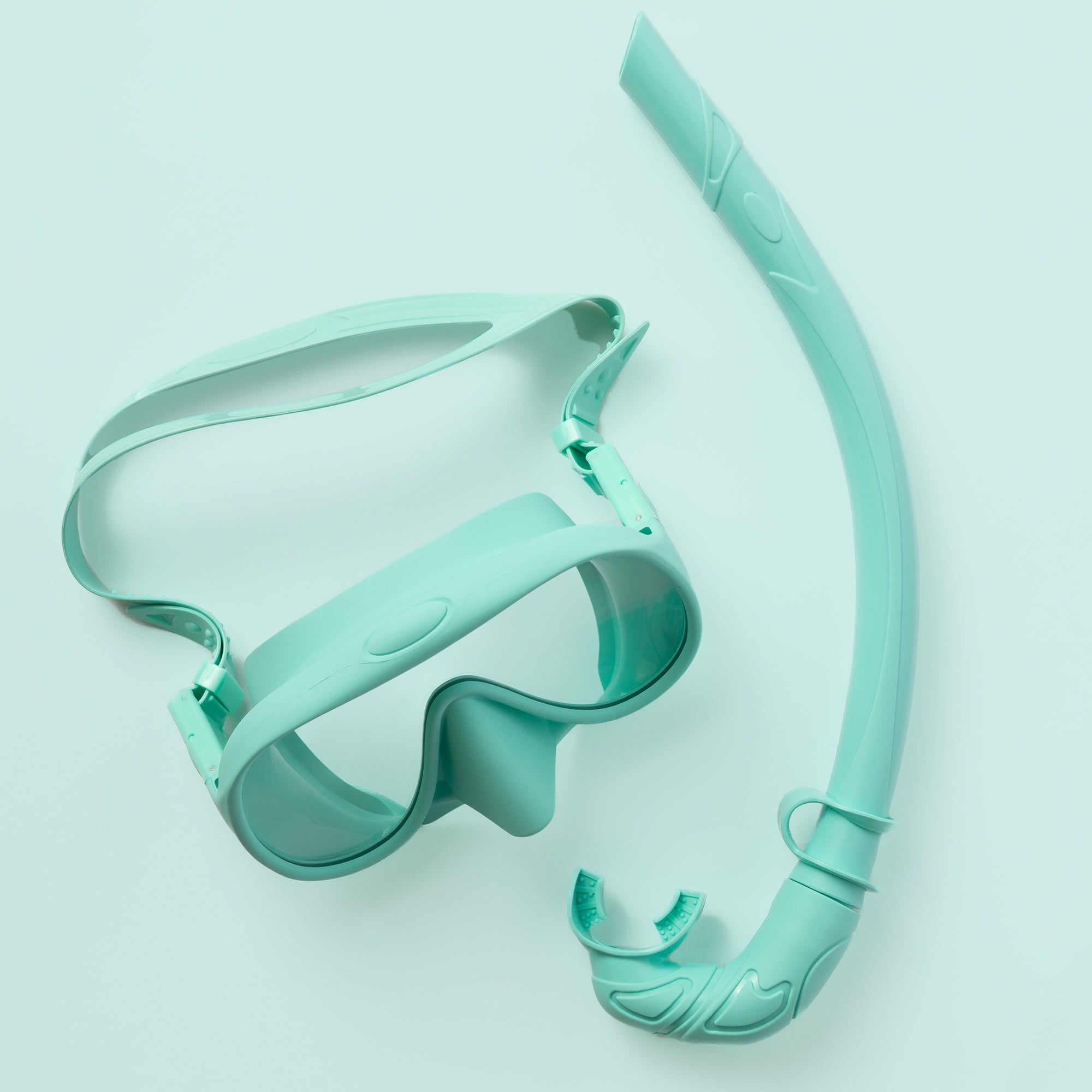 The Honey Snorkel Kit by Honey Swim includes a teal snorkel and mask set on a matching background. The goggles offer a clear, panoramic view with an adjustable strap, and the snorkel has a curved design with a mouthpiece.