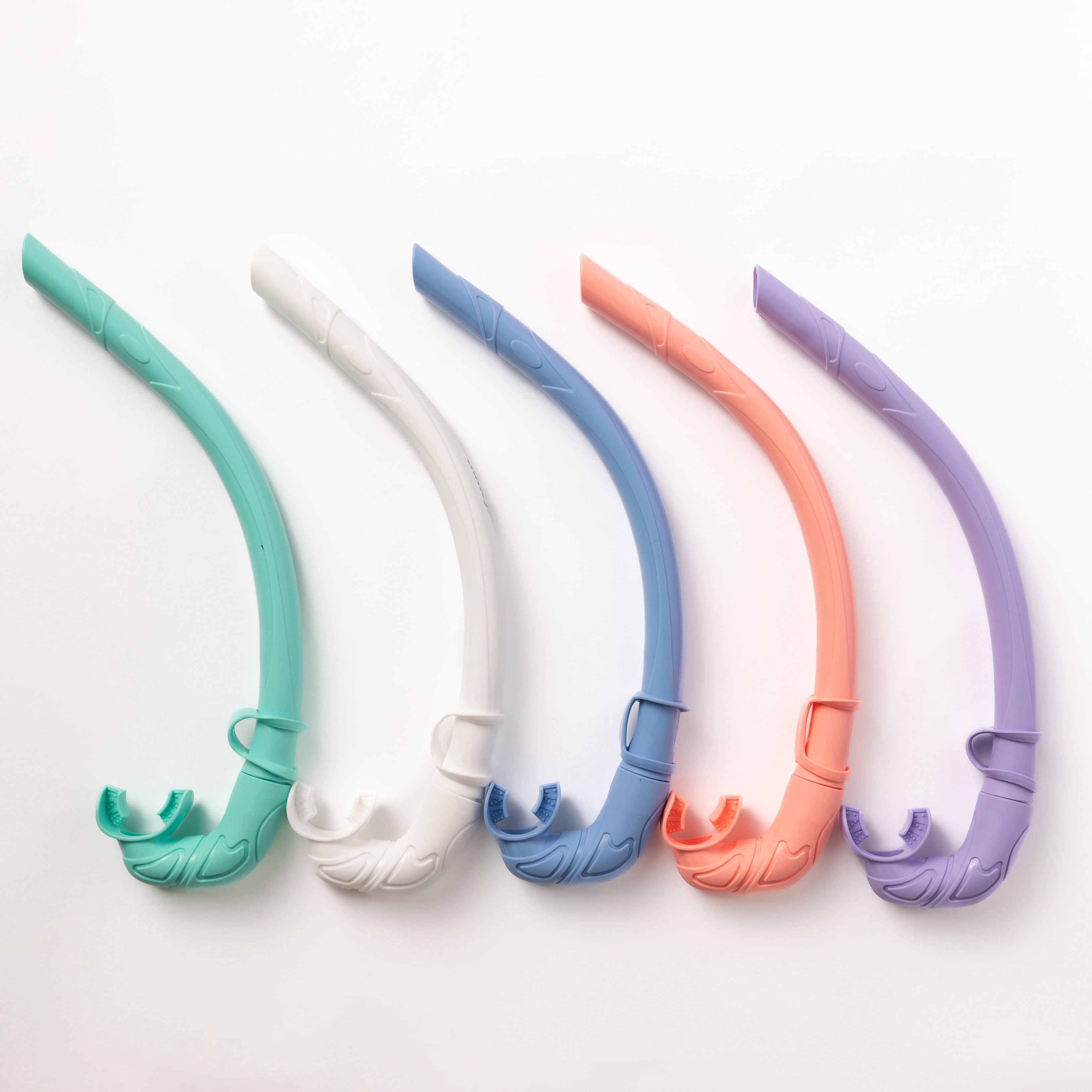 Five Honey Swim Honey Snorkels in travel-friendly pastel hues—green, white, blue, pink, and purple—are arranged vertically against a white background. Each features a curved design with a mouthpiece at the bottom.