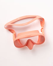 The Honey Goggles by Honey Swim, a coral-pink diving mask with tempered glass lenses and strap, offer a leak-proof fit for panoramic underwater views. The stylish design is showcased against a plain white background.