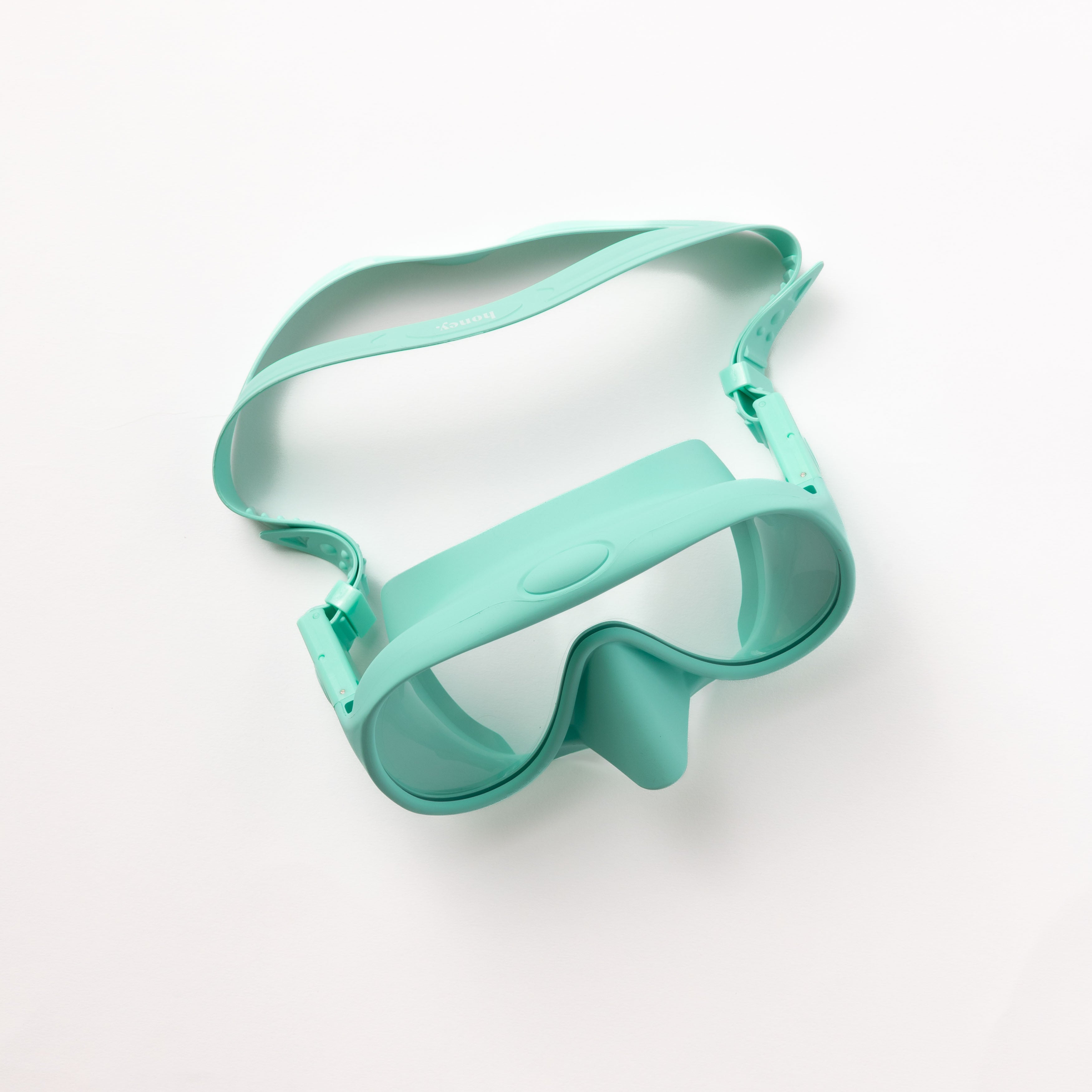 The Honey Swim Honey Goggles, an aqua-colored snorkeling mask with a wide, clear lens and adjustable strap, ensures a leak-proof fit against a white background.